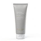 Detoxifying hair conditioner tube with 'Theorie' branding on a white background
