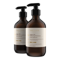 Two bottles of Theorie Argan Oil Restoring Shampoo and Conditioner on a white background